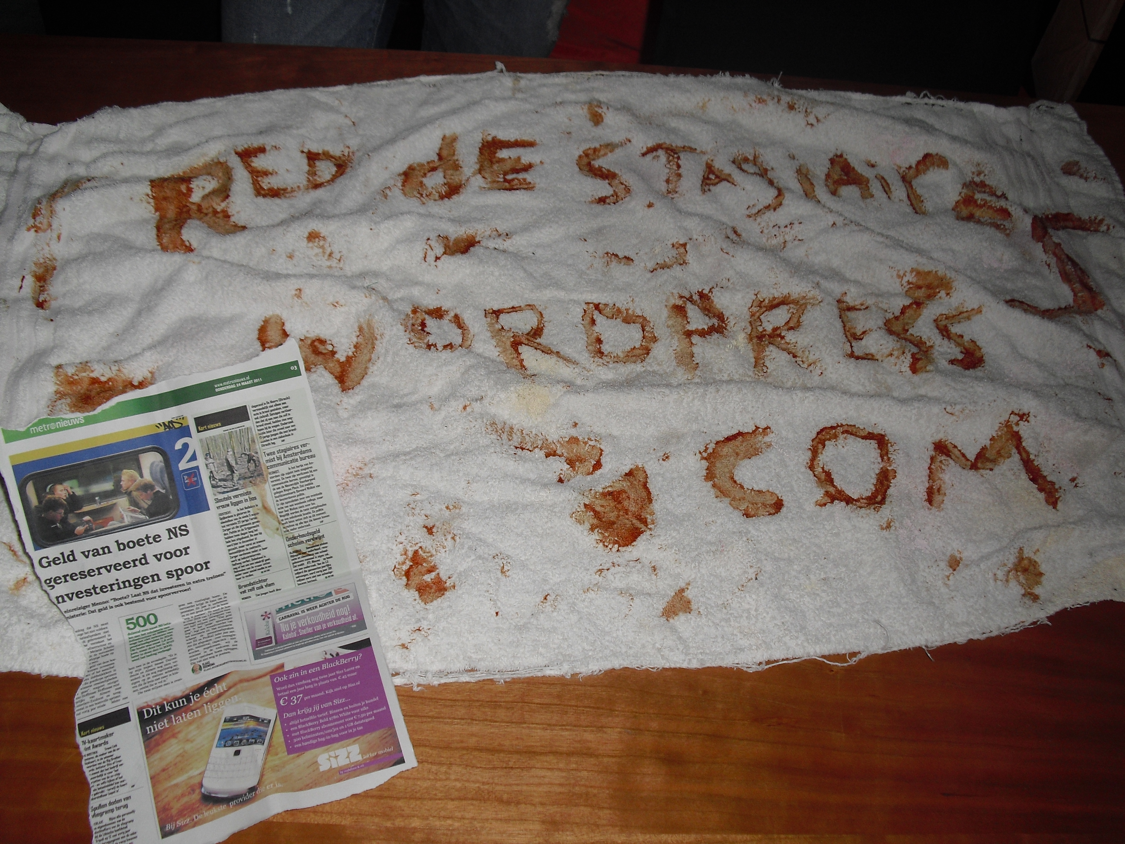 Frontpage of a newspaper and a towel with blood